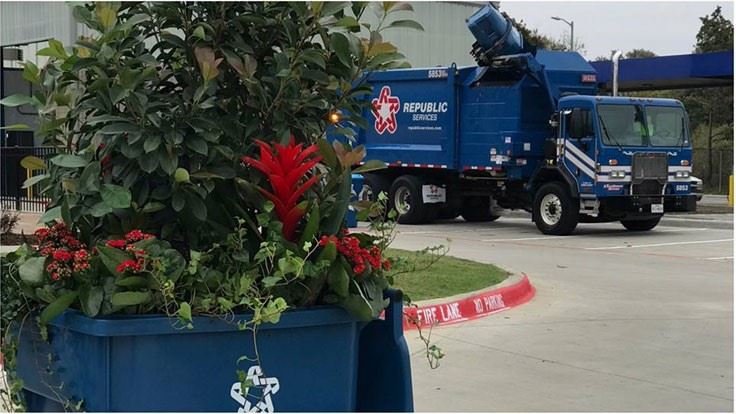 Trash truck picking up plastic trash cart